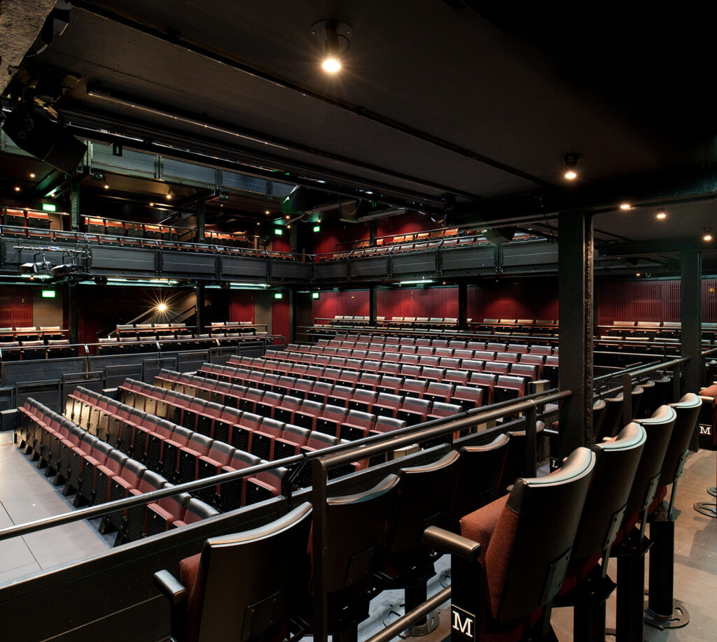 The Dorfman Theatre's seating at a low-incline configuration.