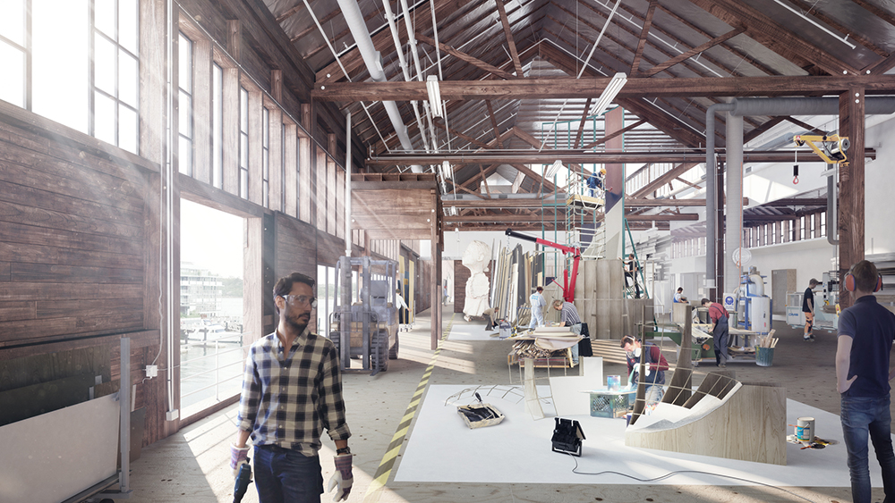 The sunlit interior of a warehouse with in progress models being built.