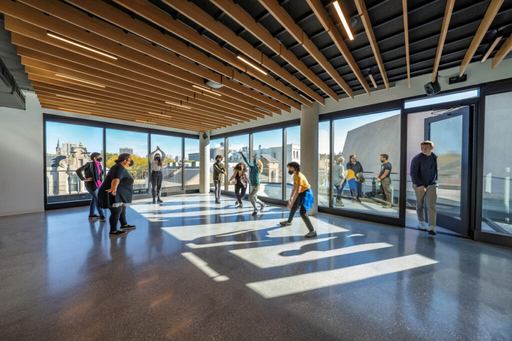 A group of people using the new sunlit education and rehearsal spaces at Steppenwolf Theatre Company.