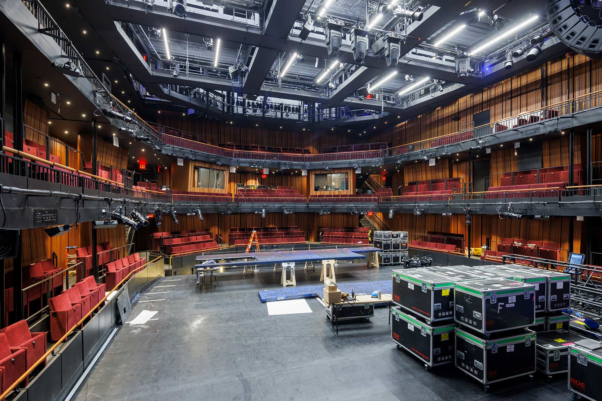 The PAC NYC theater with boxes of theater equipment stacked one one side of the stage.