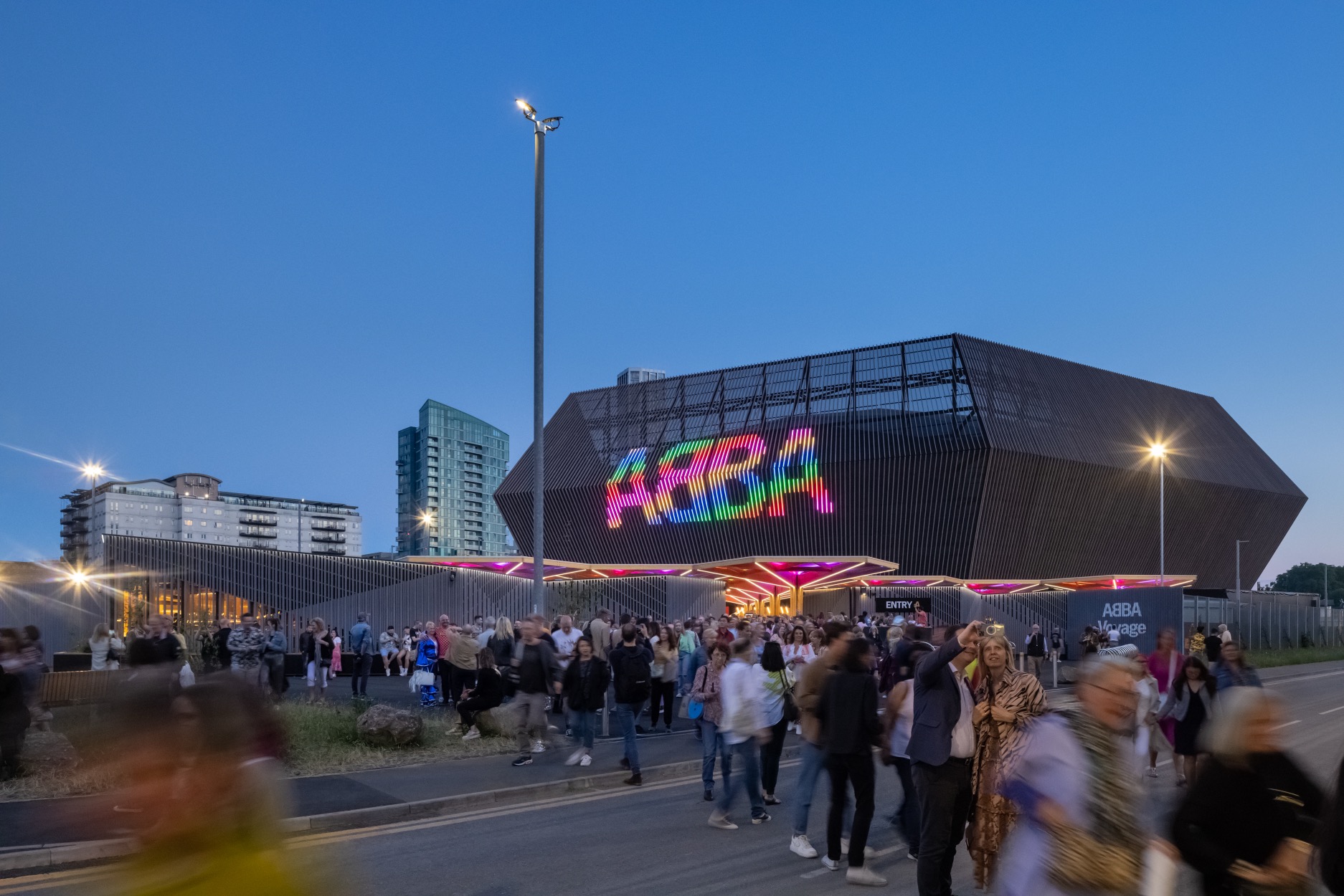 The angular arena structure seen at night with exiting audience. © Dirk Lindner courtesy of Stufish