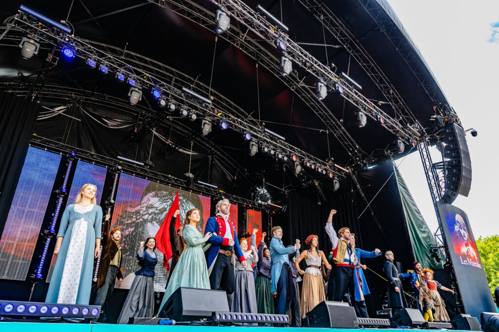 Performers on stage dressed in costume for Les Miserables.