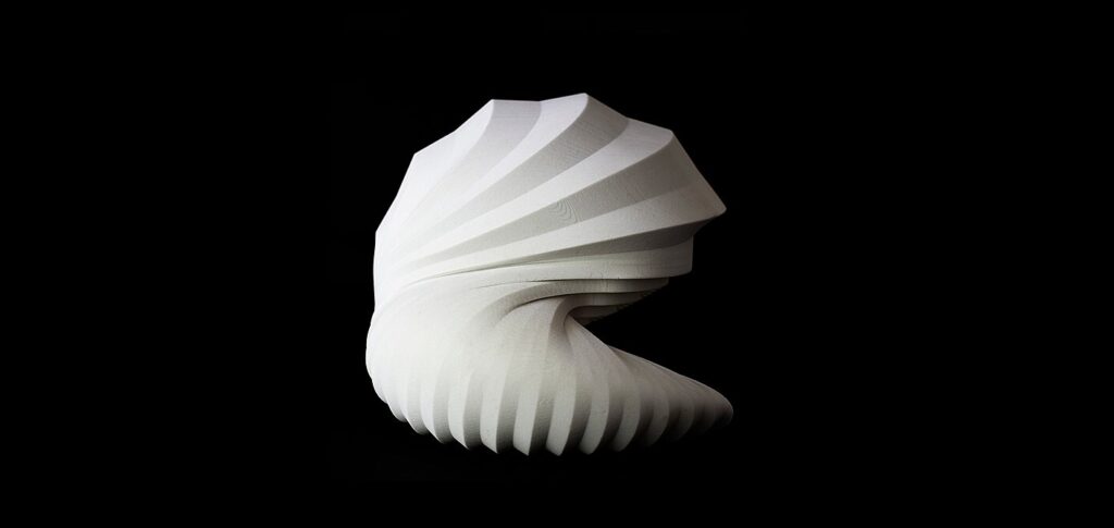 Back view of an abstract curved and corrugated white form on a black background.