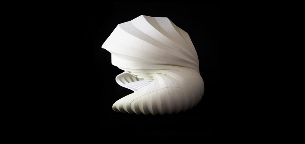 An abstract curved and corrugated white form on a black background.