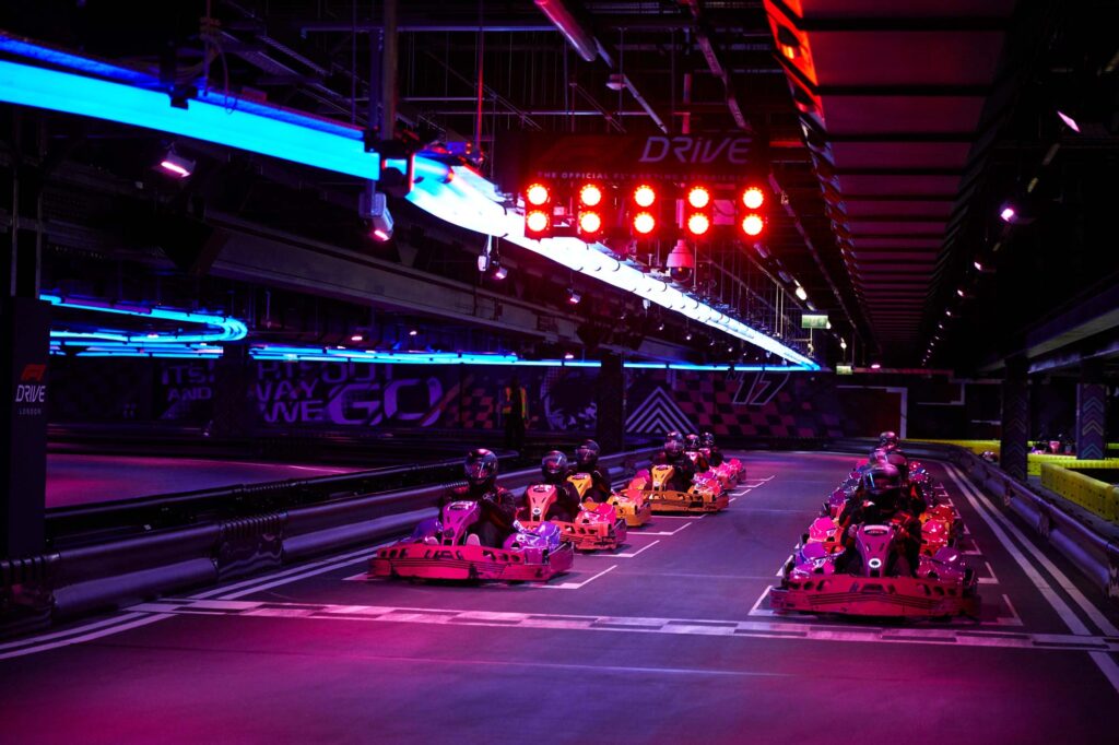 Racers line up under a red light.
