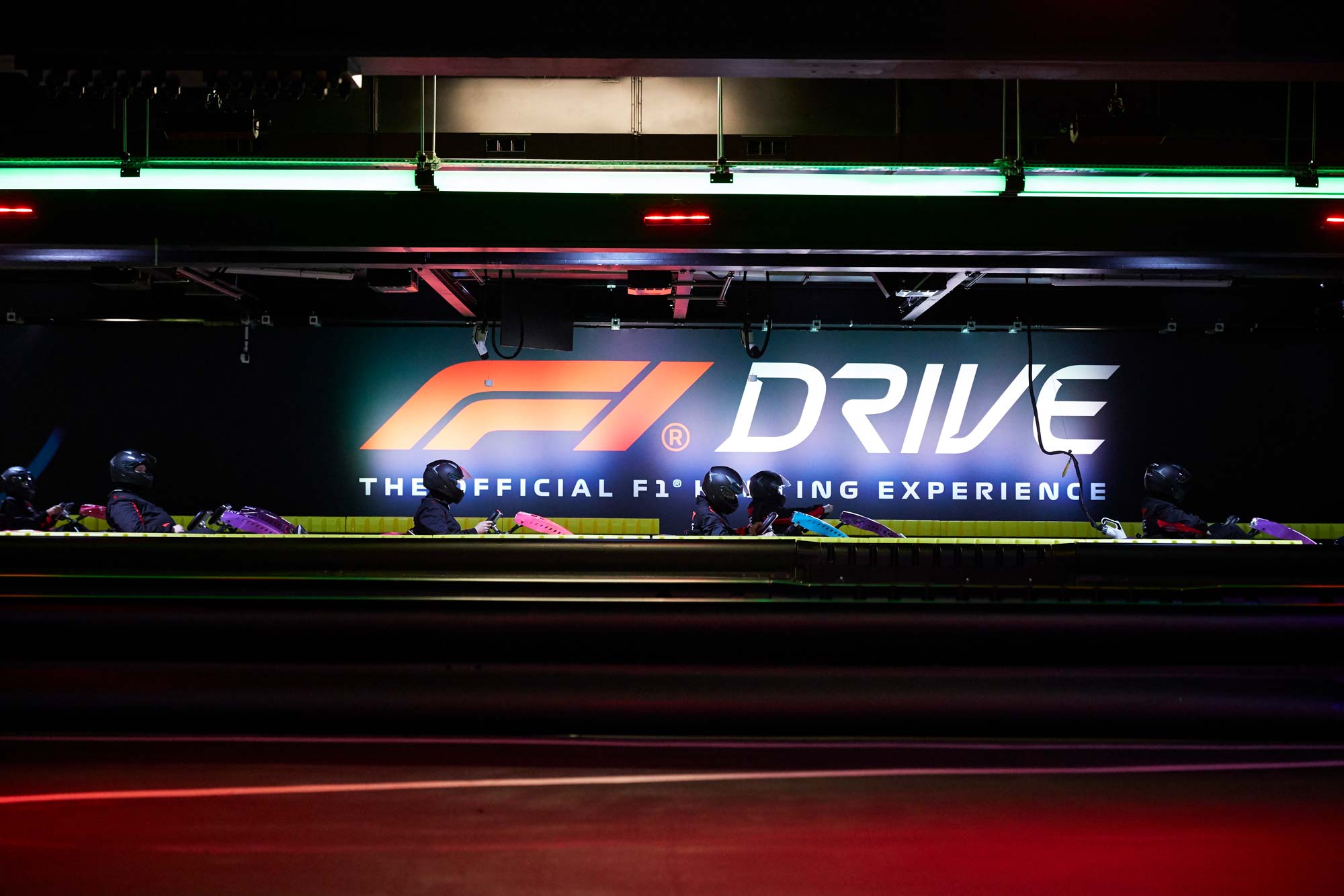 Drivers line up alongside the F1 Drive sign. Photo by Pete Muller
