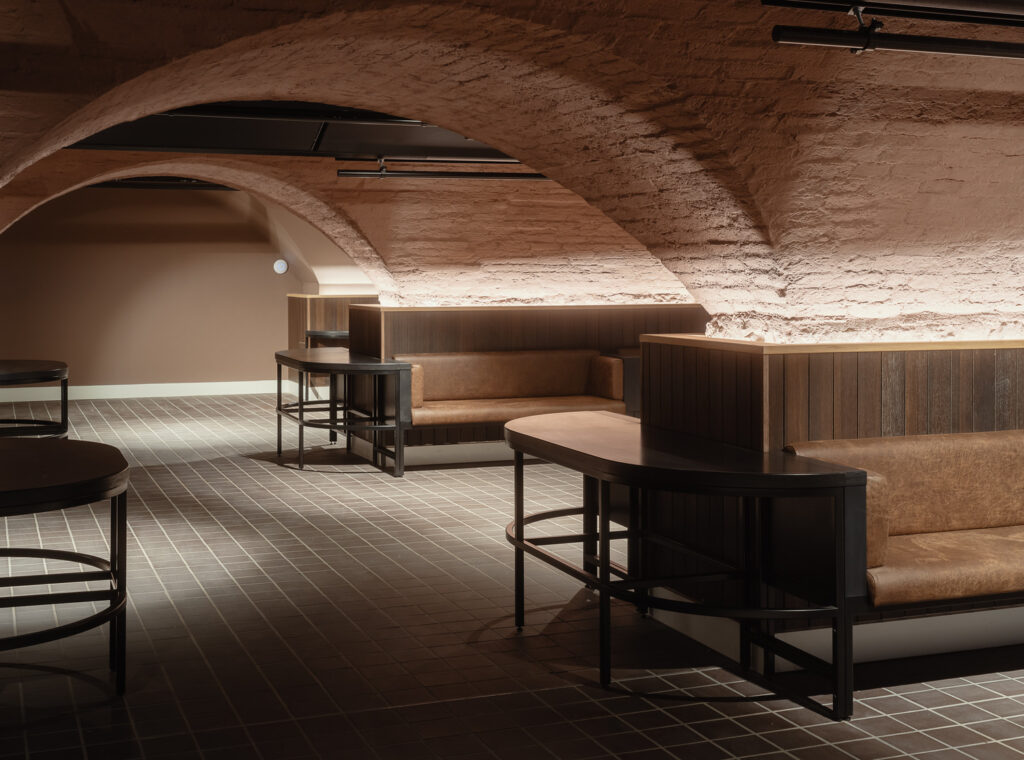 Bench seating in a room with a low vaulted ceiling.