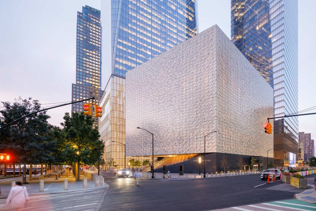 The PAC exterior gleaming under dusk lighting.