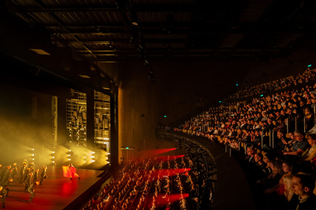 A packed audience views a dance performance at Aviva Studios, Manchester. Photo by Marco Cappelletti. Courtesy of OMA and Factory International.