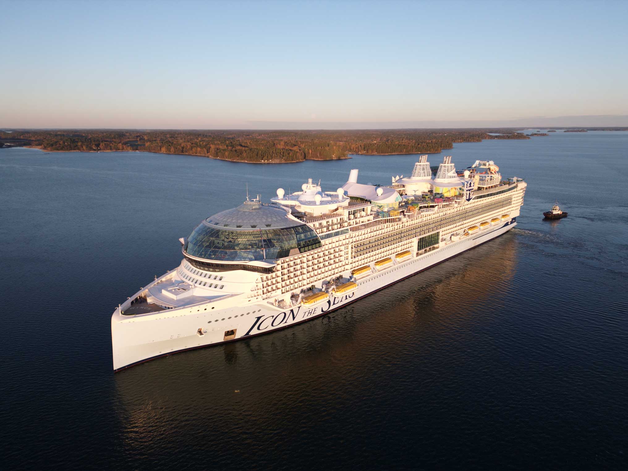 The Icon of the Seas seen from above as it traverses a bay.