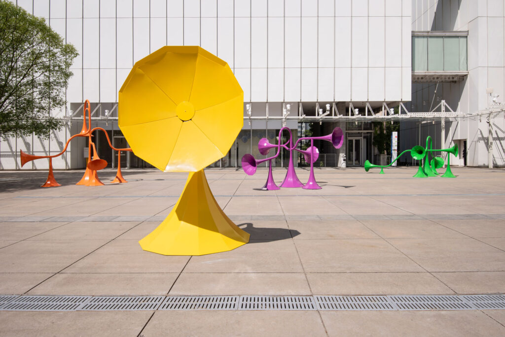 Plaza with four large colorful sound sculptures.