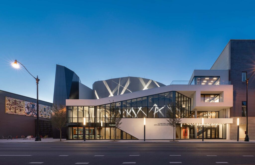 The exterior illuminated with beams of light in a searchlight pattern.