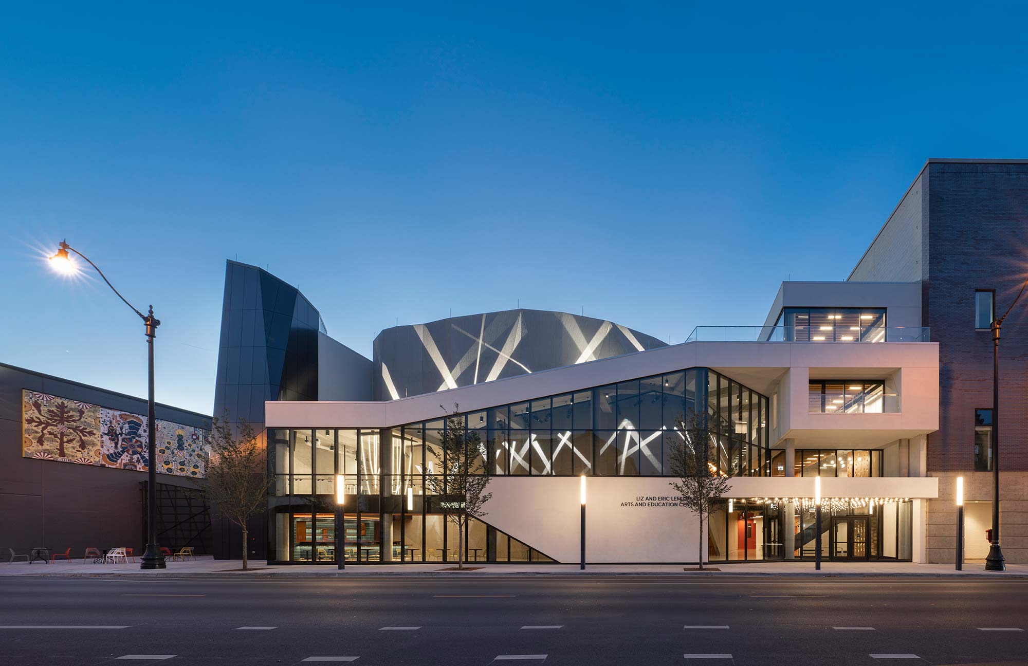 The exterior illuminated with beams of light in a searchlight pattern.
