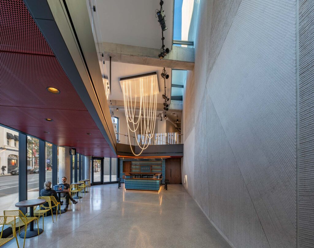 A lounge area in the lobby with draping loops of led lights over the bar.