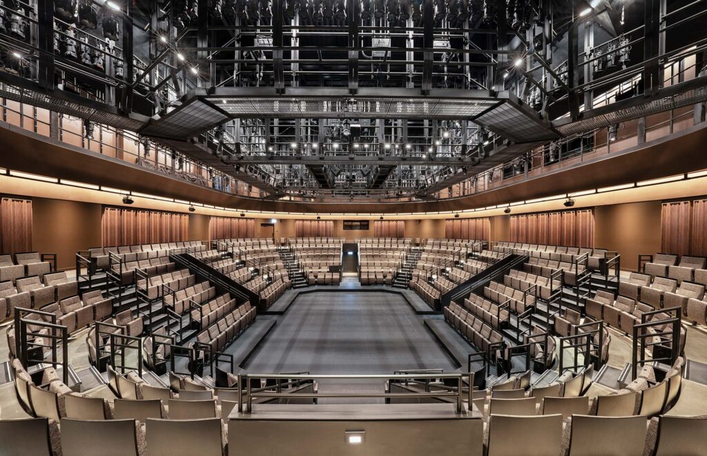The seating surrounds the performance area.