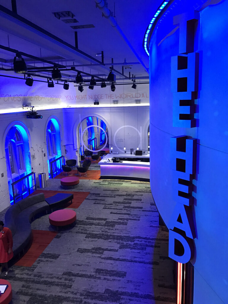View of the lobby. Words run along the walls below the ceiling. The Head sign is stacked on the right side of the image.