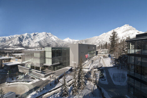 Exterior view of Banff Centre for the Arts and Creativity seen against snowy mountains.