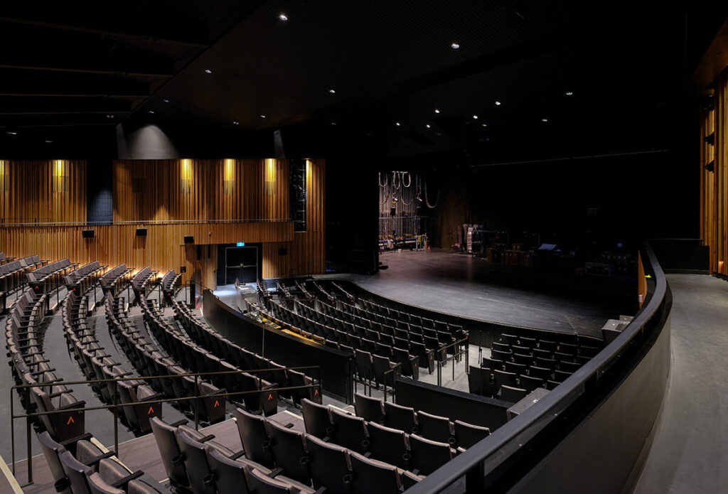 Dark seating area and stage seen from balcony. Image by Chris Couse.