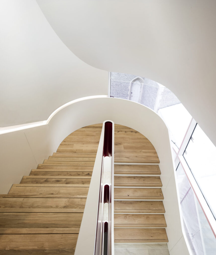 Looking down a wood finished stairwell.