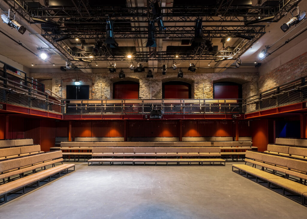 Rectangular seating benches surround the performance area at Bristol Old Vic.
