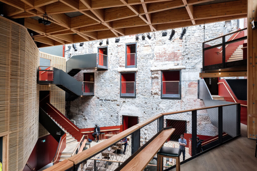 View of the rustic wall and lobby from balcony level.