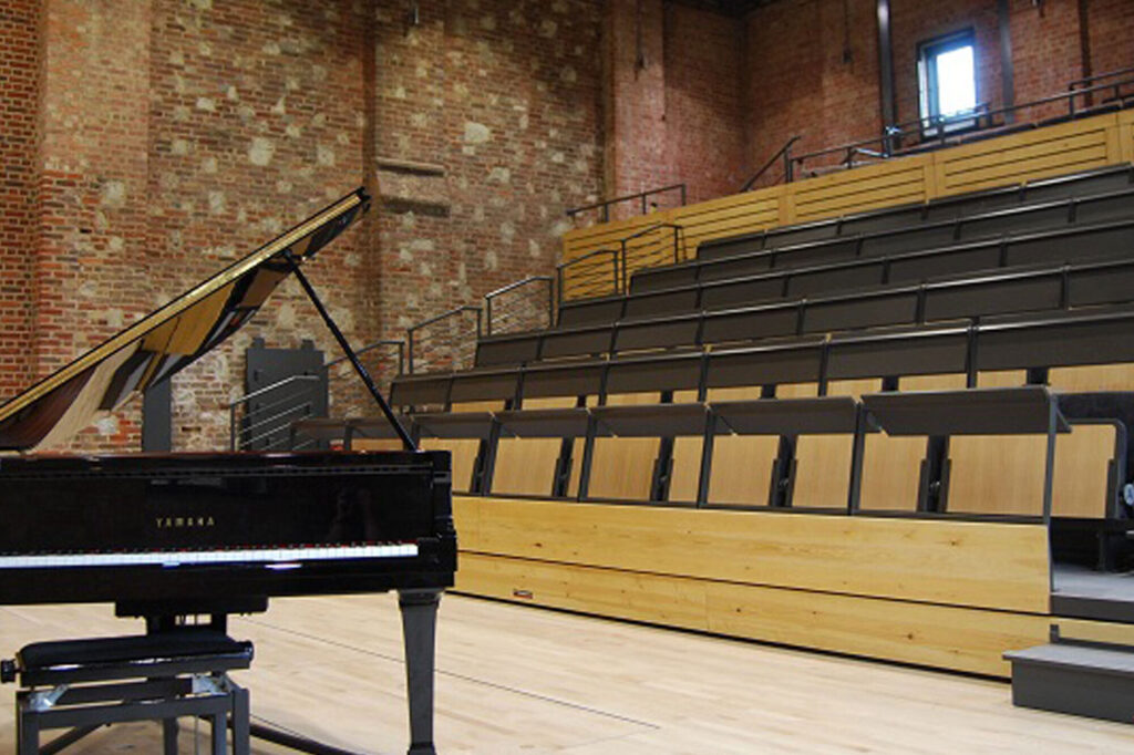 A piano an a flexible seating area.