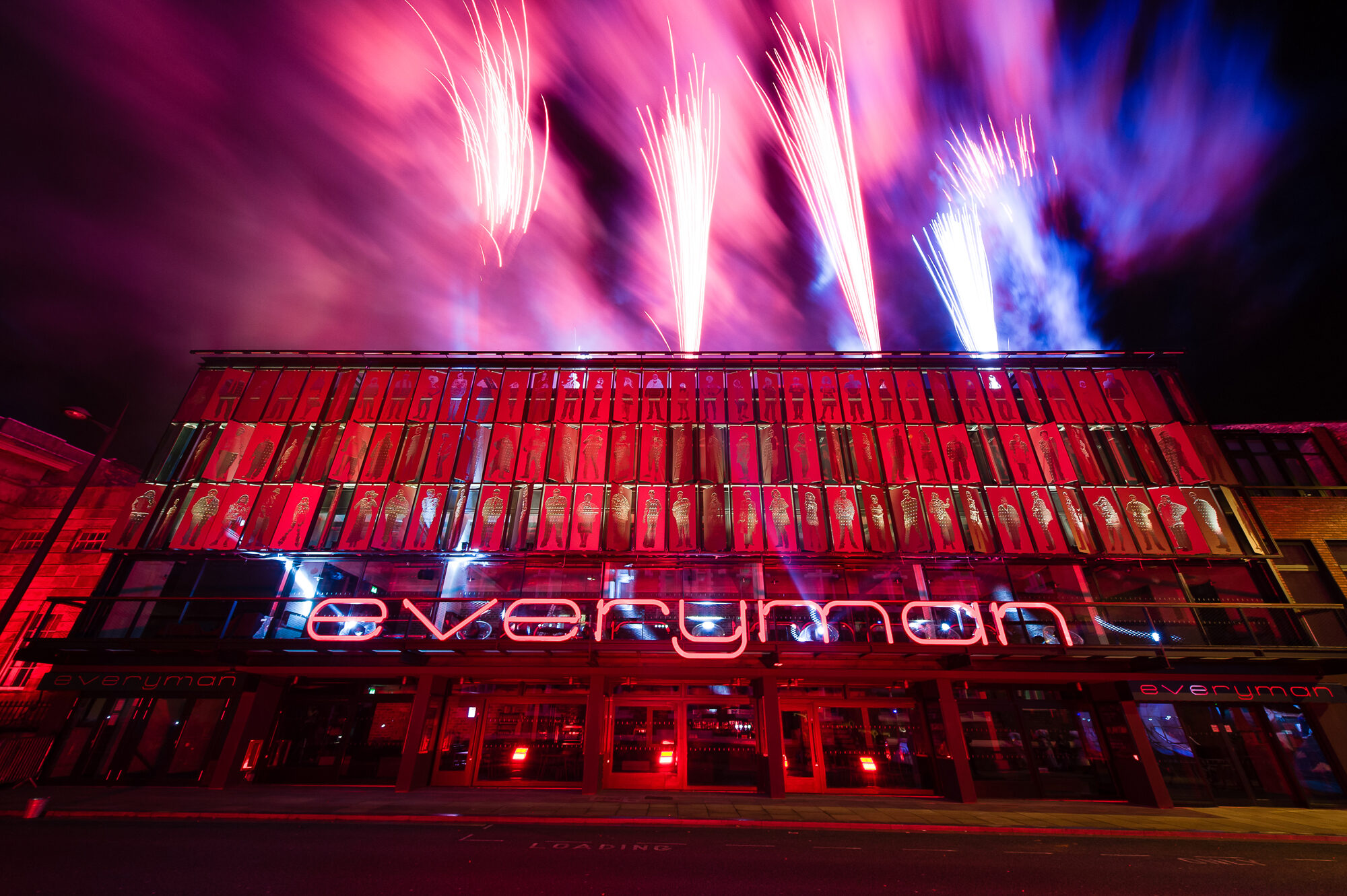 Exterior of the Everyman theatre with fireworks and silhouette art panels. Image by Pete Carr.