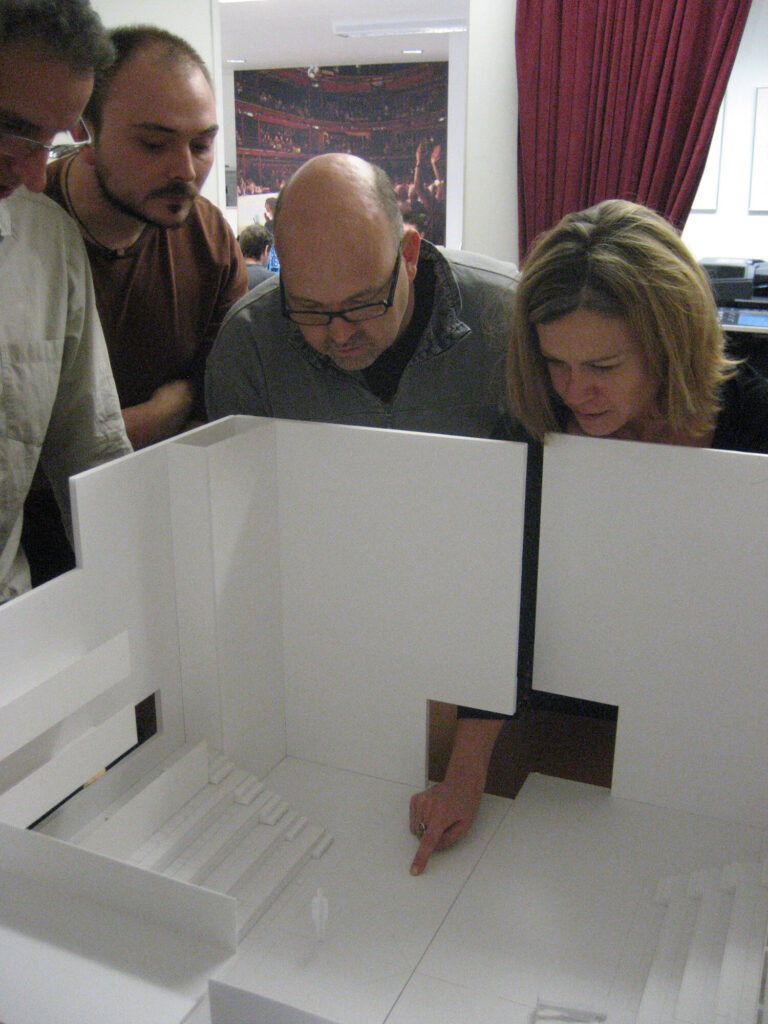 Team members study a diorama.