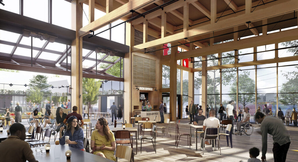 A cafe within a warehouse-like space with one wall retracted to create an open-air space.