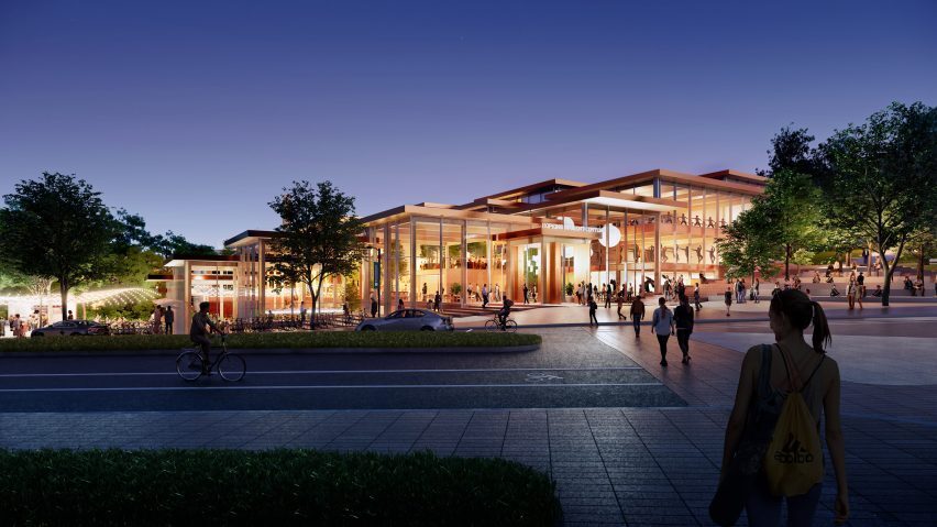 Rendering of low, tiered glass building at night.