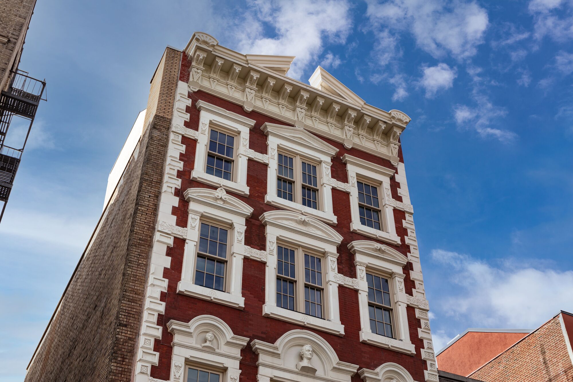 The red brick and white trim windows on the exterior of Mama's building. Images by John Bartelstone Photography