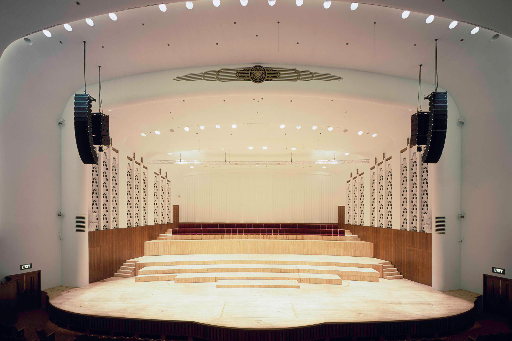 A decorative white stage with wooden risers and seating.