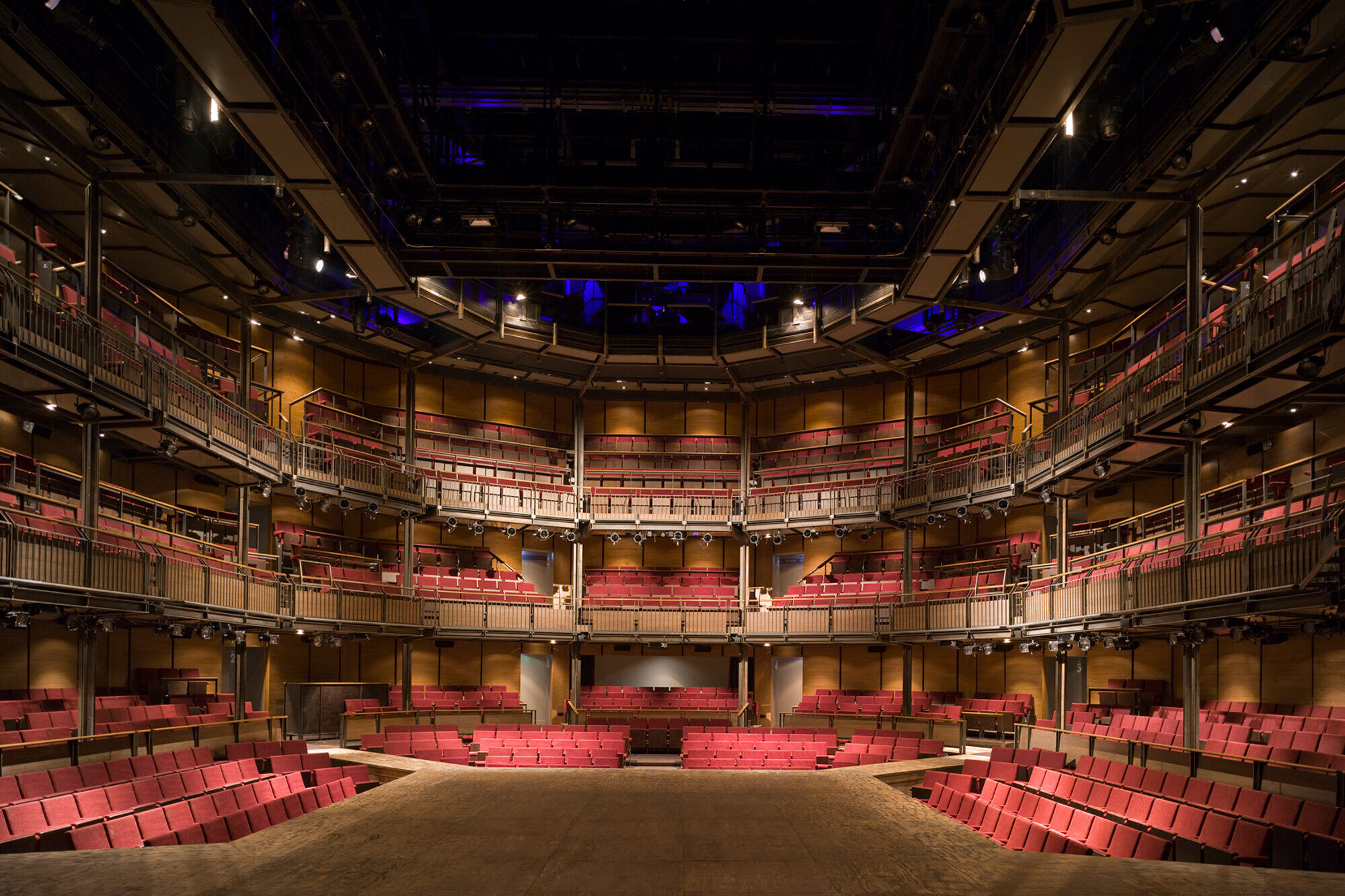 The empty stage with multiple paths offstage for performers.