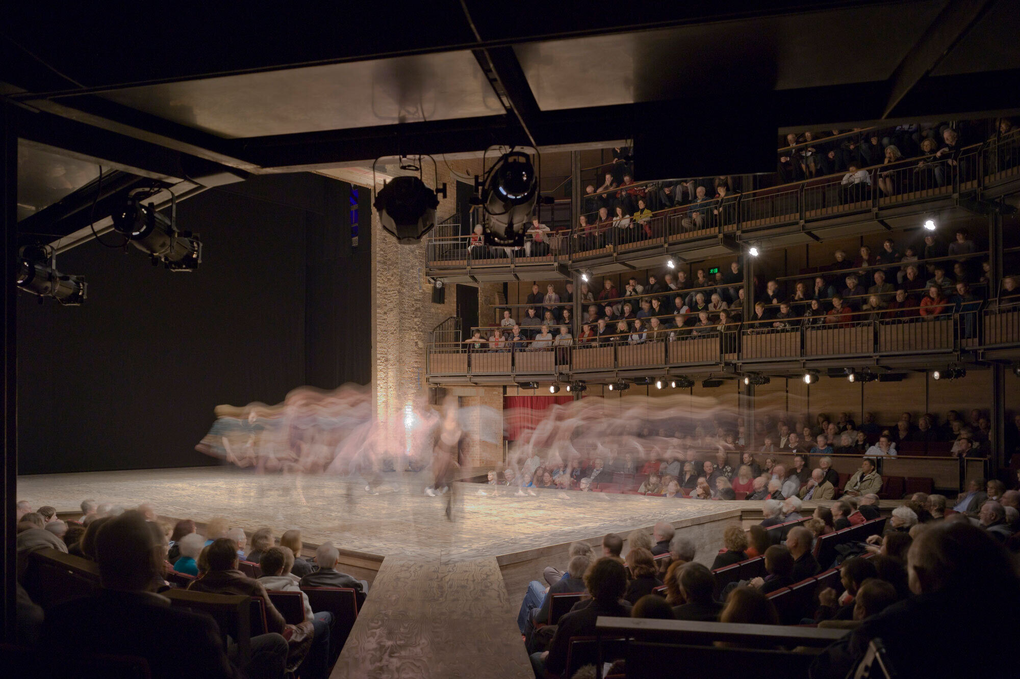 A long exposure image of a performer on stage.
