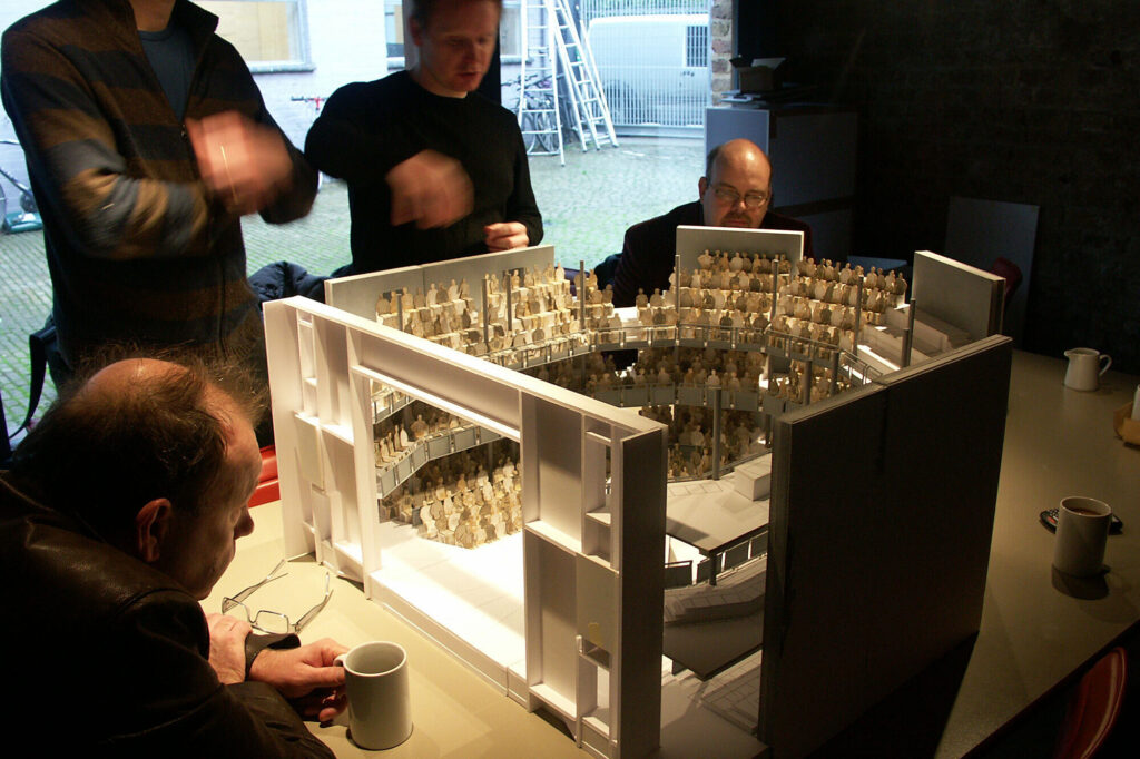 The team reviews a mockup of the stage and audience.