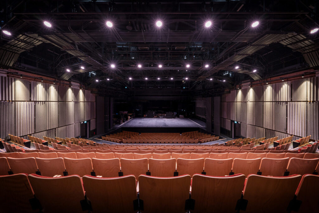 Seating area set back from performance stage in a more traditional arrangement.