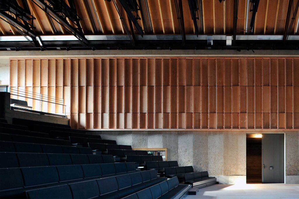 A seating area with dimensional wood paneling running along the wall.