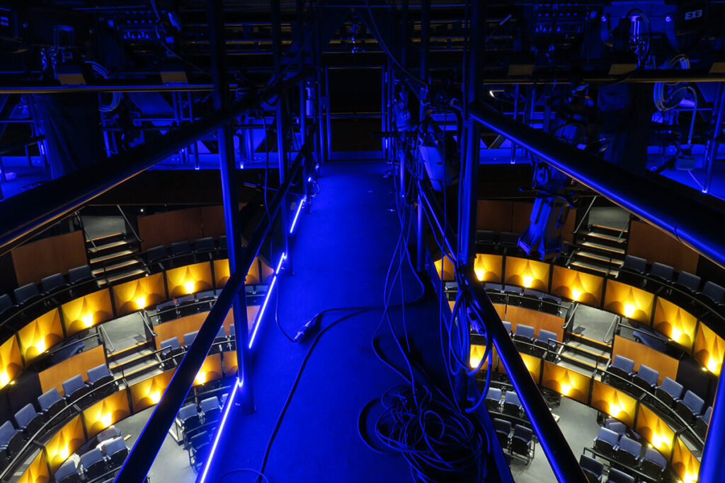 Looking down from catwalk at @Sohoplace with dramatic blue and yellow lighting. Image by Alex Wardle.