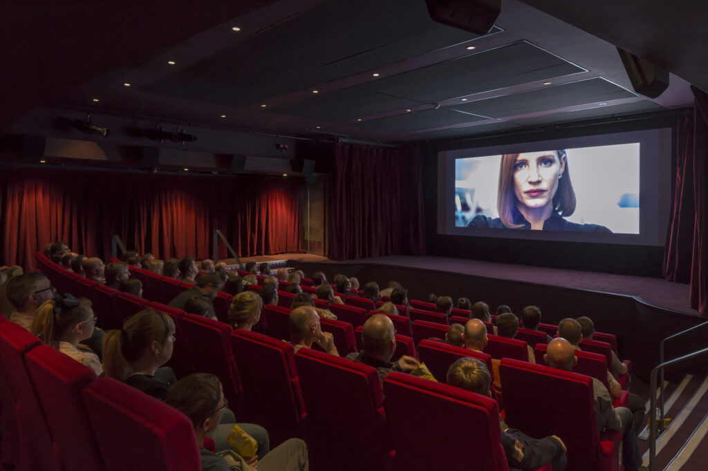 People watch a screening in an intimate theatre space. Photo by Peter Cook.