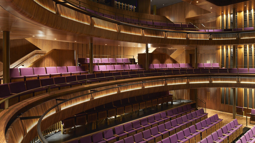 Three levels of purple seating with elegant wood details.