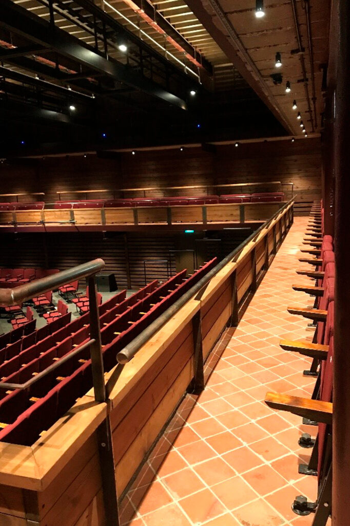 The upper balcony has folding seats and terra cotta floor tile.