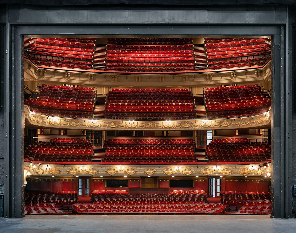 View of four seating levels framed by the stage, seen from back of house.