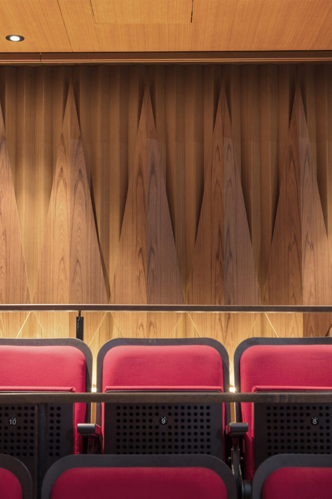 Seat detail at W!ld Rice with corrugated and triangular wood wall details behind.
