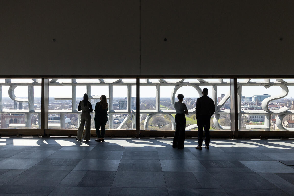 Visitors look out of the Obama Presidential Center.